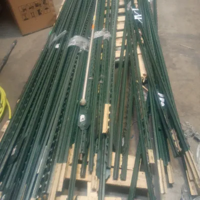 Sale Photo Thumbnail #14: Large stack of green steel T-posts for fencing, laid out on a wooden pallet.