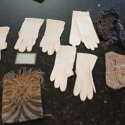 Collection of vintage ladies' dress accessories, including several pairs of white dress gloves, three beaded drawstring purses, and...