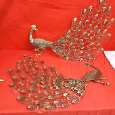 Pair of vintage mid-century brass and metal peacock wall sculptures featuring elaborate fan-tail feather details.