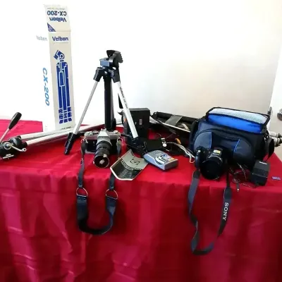 Collection of photography equipment including a Velbon CX-200 tripod with original box, a vintage 35mm SLR camera, a Sony digital camera,...