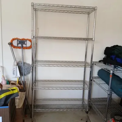 Tall, five-tier chrome wire shelving unit in good condition, suitable for garage or pantry storage.