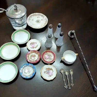 Collection of vintage miniature porcelain butter chips, small decorative saucers, glass salt shakers, small silver spoons, a glass...