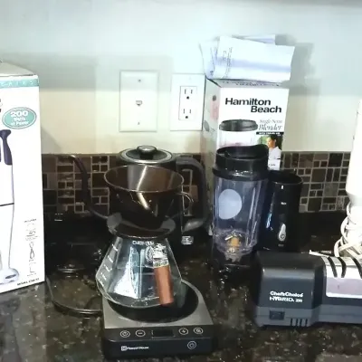 Collection of small kitchen appliances including a Cuisinart hand blender with box, a pour-over coffee set with electric base, a Hamilton...