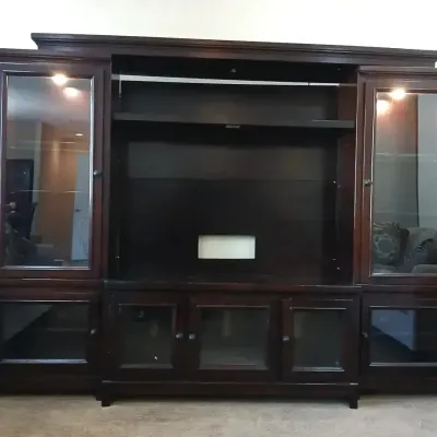 Large dark espresso-finished entertainment center with glass-front side display cabinets and lower media storage doors.
