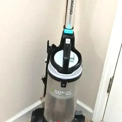 Bissell CleanView Swivel Reach upright vacuum cleaner in teal and black, showing minor signs of use.