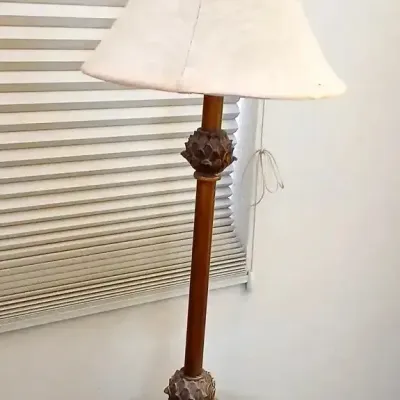 Tall traditional buffet table lamp featuring a carved pineapple-motif base with a bronze-toned finish and an off-white bell shade.
