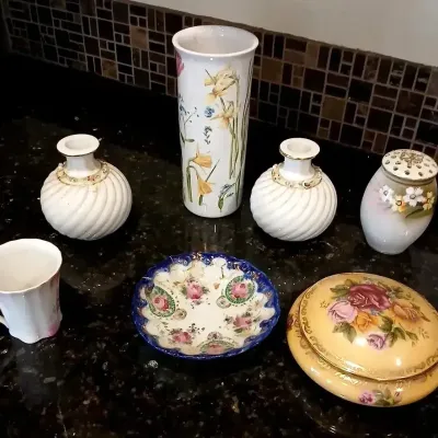 Collection of vintage floral porcelain items, including a pair of swirl-patterned vases, a tall cylinder vase, a covered trinket dish, a...
