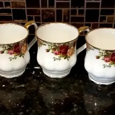 Set of five Royal Albert Old Country Roses fine bone china coffee mugs, featuring gold trim and signature floral motifs.