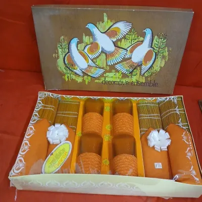 Vintage Milano 'Decorative Ensemble' table setting gift set, featuring orange napkins, woven placemats, and four wrapped...