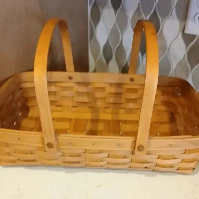 Rectangular Longaberger-style woven wood splint basket with double stationary handles.