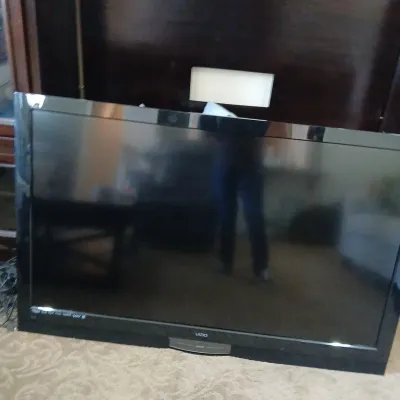Vizio flat-screen LCD television in a black frame, resting on the floor.