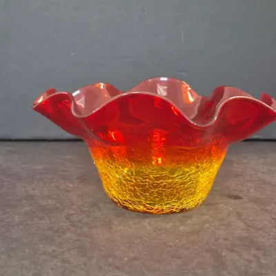Sale Photo Thumbnail #38: Vintage Amberina crackle glass bowl featuring a ruffled, fluted rim and an ombre transition from ruby red to golden yellow.