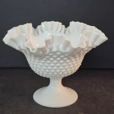 Sale Photo Thumbnail #37: Vintage Fenton white milk glass hobnail pedestal dish featuring a double-ruffled crimped rim.