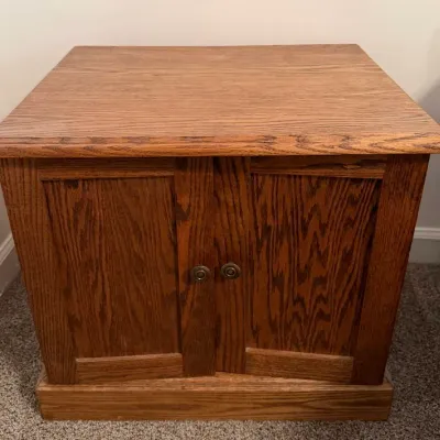 Traditional Oak Two-Door Storage Cabinet with Paneled Doors & Warm Wood Grain Finish