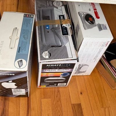 Collection of boxed electronics including an Apple Mac Pro box, Ion USB turntable, AlwaysAire queen air mattress, Samsung monitor box,...