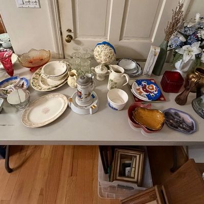 Collection of vintage tabletop items including glassware, ceramic pitchers, serving platters, a beer stein, and decorative brass objects...