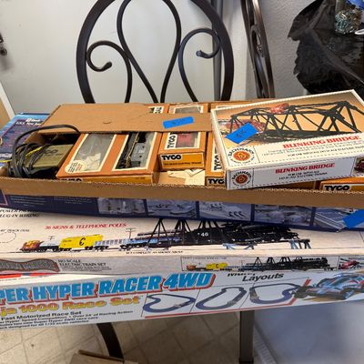 Collection of vintage boxed model train sets and accessories including Tyco, Bachmann, and a Super Hyper Racer 4WD race set, circa...