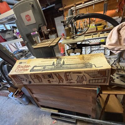 Vintage Sears Craftsman Router-Crafter in original box, displayed alongside various workshop power tools, including a Shopsmith bandsaw.
