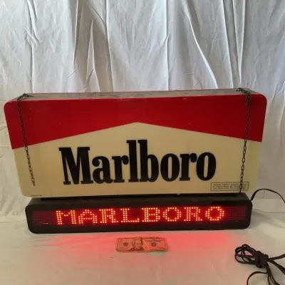 Vintage Marlboro illuminated cigarette sign featuring a hanging chain mount and a bottom digital LED ticker reading MARLBORO in red lights.