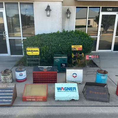 Collection of vintage automotive memorabilia and store displays, including oil cans from Conoco, Sinclair, and Standard, alongside...