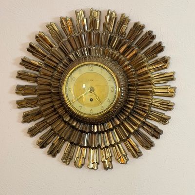 Vintage Welby mid-century sunburst wall clock in a molded gilt or bronze-tone finish, featuring an 8-day wind-up mechanism.