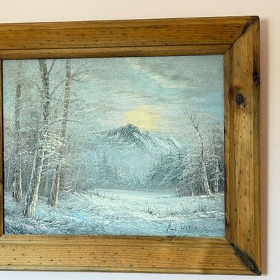 Framed oil painting depicting a snowy mountain winter landscape with birch trees, signed Paul Weston, housed in a rustic wooden frame.