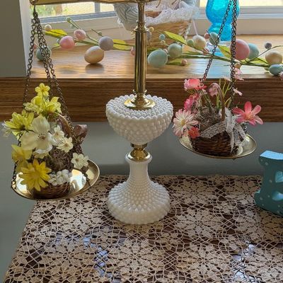 Vintage brass balance scale scale featuring a Fenton white hobnail milk glass base and stem, decorated with small woven baskets of faux...