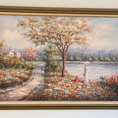 Framed impressionist-style oil painting depicting a woman with a parasol in a lush garden landscape near a lake, set in a gold-finished...