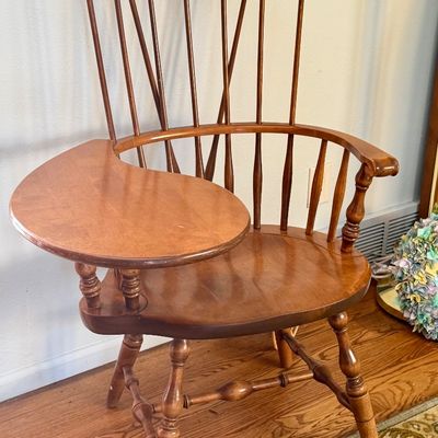 Vintage Windsor-style writing armchair crafted from hardwood, featuring a comb back, turned legs, and an attached right-hand paddle desk...