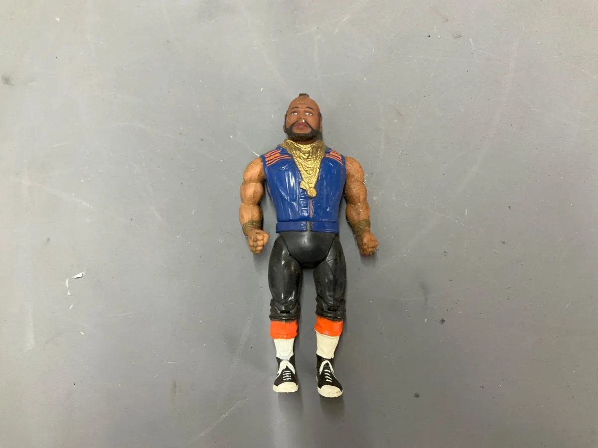 Sale Photo Thumbnail #340: Vintage 1980s Mr. T action figure by Galoob, featuring his signature gold chains, blue vest, and boots with minor wear to the paint.