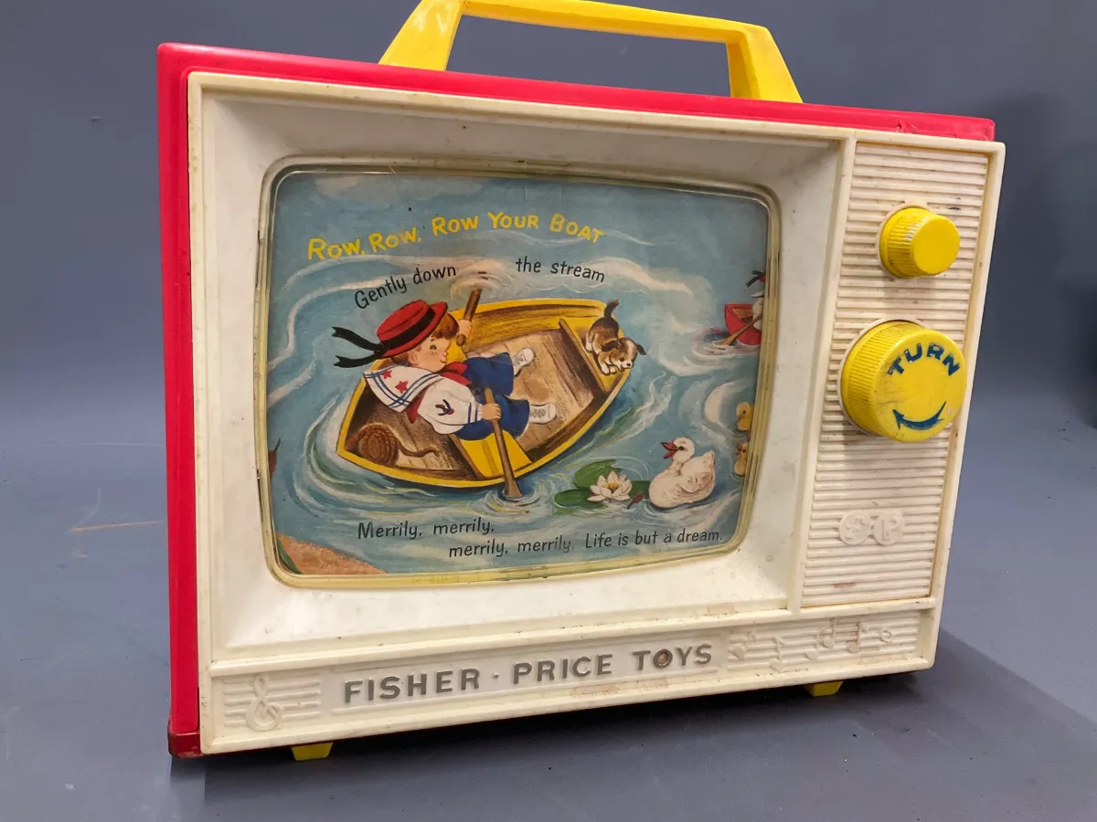 Sale Photo Thumbnail #338: Vintage Fisher-Price musical TV toy featuring 'Row, Row, Row Your Boat' graphics. Shows light surface wear and discoloration typical of age.