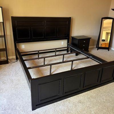 Contemporary dark espresso wood king-size bed frame featuring a paneled headboard, footboard, and internal metal support slats.