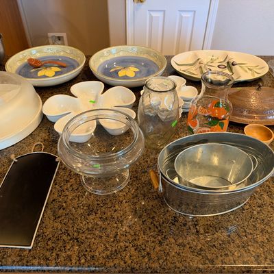 Collection of kitchenware and entertaining items, including galvanized metal tubs, Tuscan-style serving bowls, glassware, and a copper...