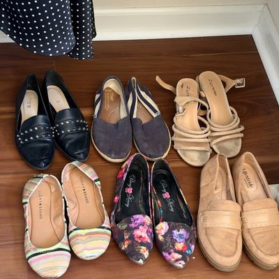 Collection of women's shoes featuring various styles including flats, loafers, espadrilles, and strappy sandals from brands like...
