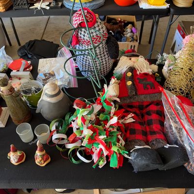Sale Photo Thumbnail #121: Collection of holiday decorations, including a plush Santa Claus, wire cone Christmas trees, gnomes, and festive ribbons.