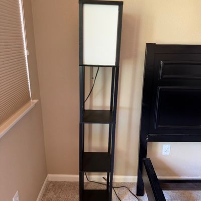 Modern black wooden shelf floor lamp featuring a white fabric shade and pull-chain switch.