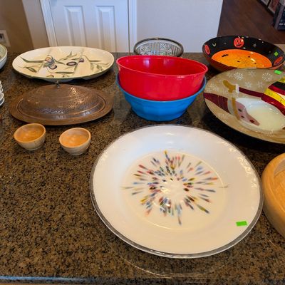 Collection of assorted kitchenware and serveware, including ceramic olive tray, festive holiday bowls, colorful nesting bowls, small...