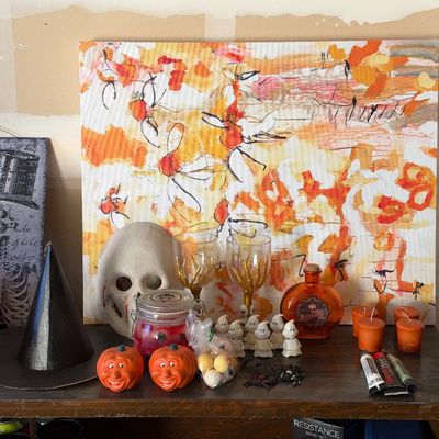 Sale Photo Thumbnail #149: Collection of Halloween decor items including a skull mask, miniature ghost figurines, pumpkin figures, witch hat, decorative glassware, and a large abstract canvas painting.
