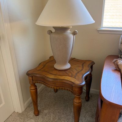 Traditional oak side table with inlaid parquetry top and turned legs, topped with a ceramic urn-style table lamp.