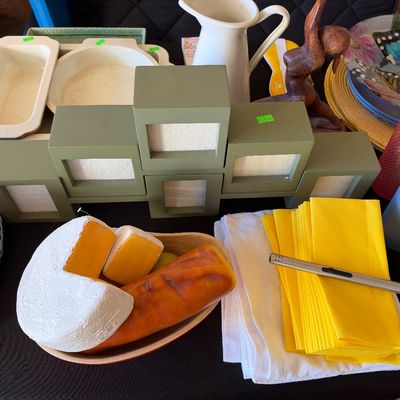 Sale Photo Thumbnail #161: Selection of household items including decorative faux food, a green multi-opening picture frame, linend and napkins, ceramic bakeware, and glassware.