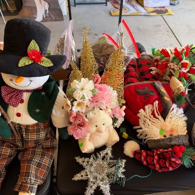 Sale Photo Thumbnail #129: Collection of holiday decorations including plush figures of a snowman, Santa, and penguin, along with wire Christmas trees and a star tree topper.