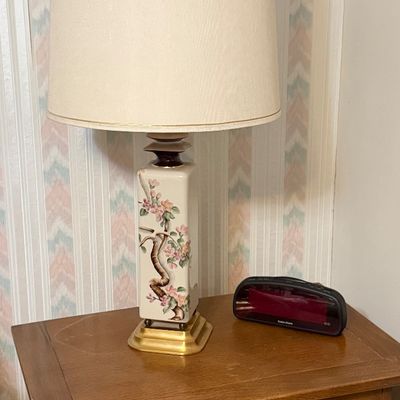 Vintage Asian-style ceramic table lamp featuring a hand-painted floral branch design, mounted on a brass base and topped with a large...