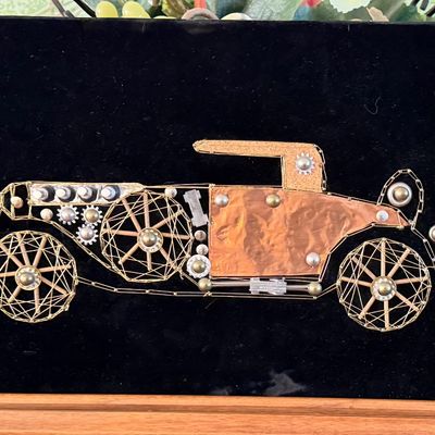 Vintage mid-century assemblage string art depicting an antique automobile, mounted on a black velvet backing.