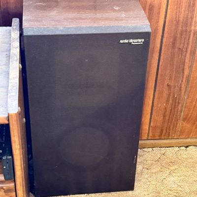 Vintage Panasonic Turbo Thrusters floor speaker featuring a faux wood grain cabinet and black fabric grill cloth.
