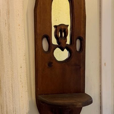 Vintage carved wooden wall shelf featuring a small inset mirror and an owl cutout design.
