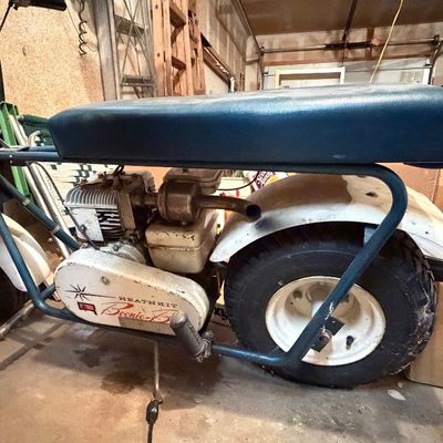 Vintage Heathkit Boonie-Bike mini bike with blue tubular steel frame, padded vinyl seat, and white fenders.