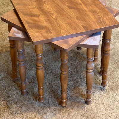 Set of three vintage mid-century wooden nesting side tables with turned spindle legs and square tops.