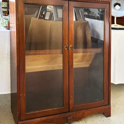 Sale Photo Thumbnail #267: Vintage mahogany display cabinet featuring double glass doors, carved egg-and-dart top molding, and bracket feet.