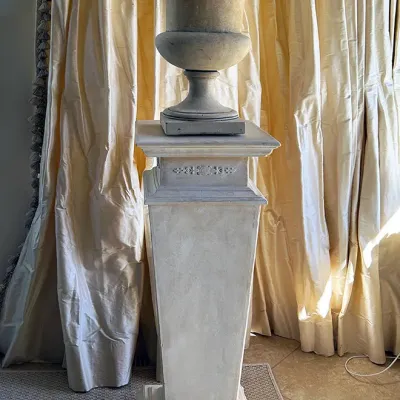 Sale Photo Thumbnail #142: Classical-style stone urn planter resting atop a tall matching pedestal column, featuring detailed relief moldings.