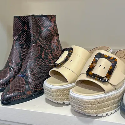 Sale Photo Thumbnail #191: Pair of faux snakeskin pointed-toe ankle boots alongside cream Sam Edelman platform espadrille sandals with tortoise shell buckles.